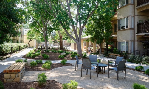 a courtyard with a table and chairs