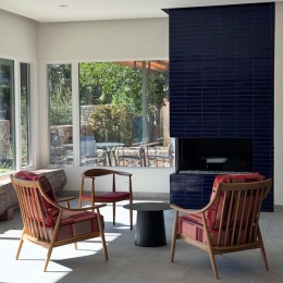 a room with chairs and a fireplace
