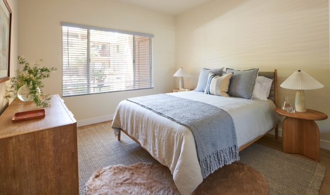a bedroom with a bed and two nightstands